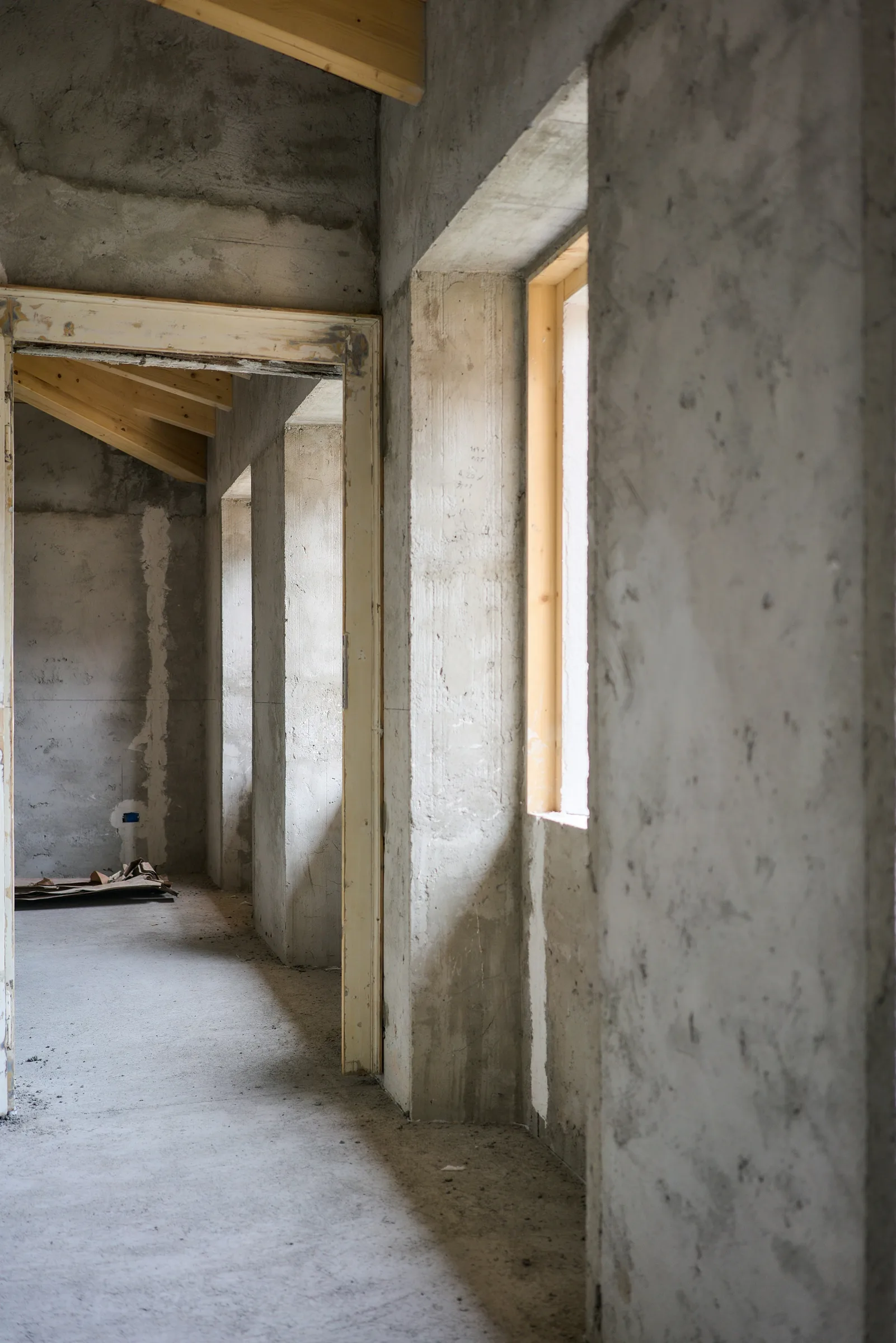 Illustrative room under construction with bare concrete walls
