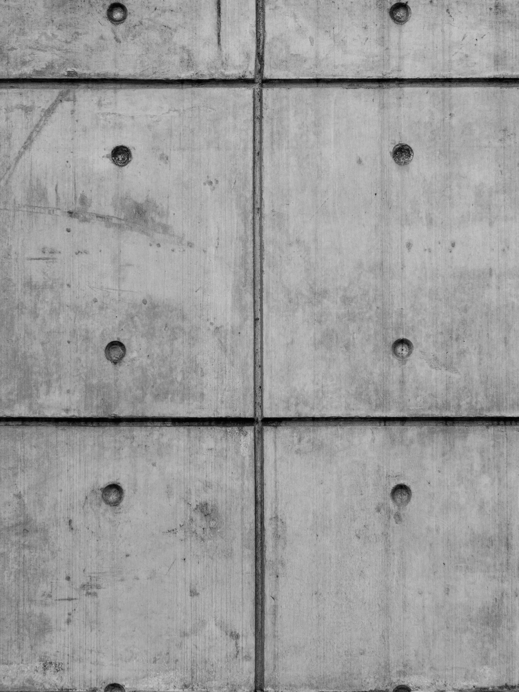 Illustrative board-formed concrete wall with form tie holes